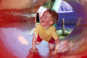child in play tunnel