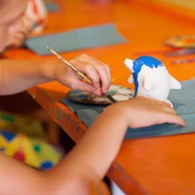 Child decorating pottery